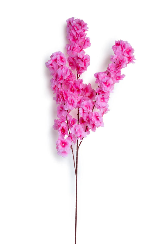 Vara de cerezo artificial color rosa fucsia con flores de apariencia realista sobre tallo café, ideal para arreglos florales, centros de mesa, decoración del hogar, escaparates y eventos.