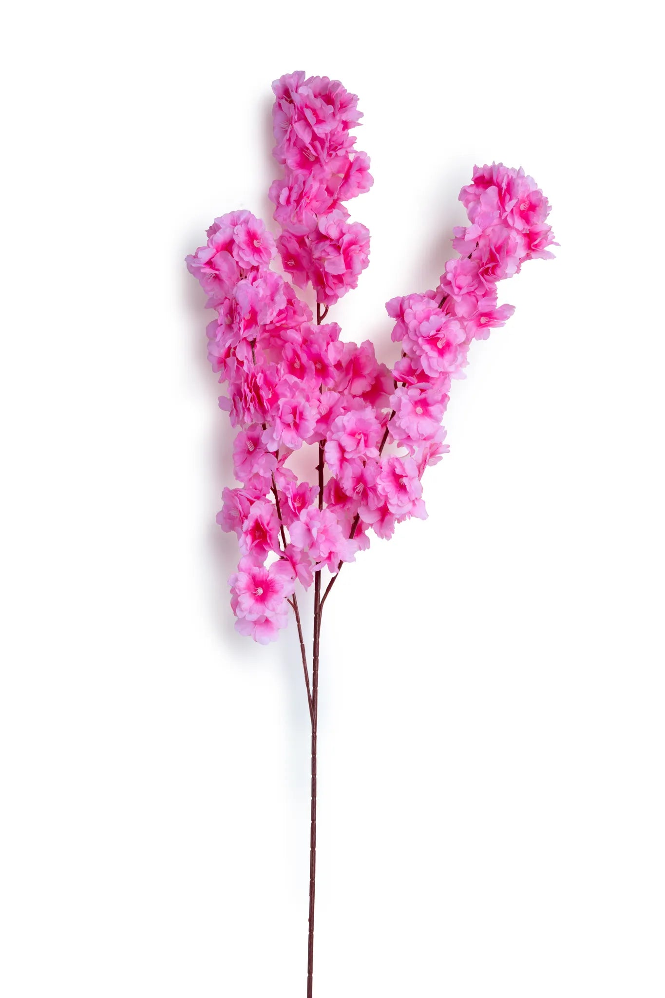 Vara de cerezo artificial color rosa fucsia con flores de apariencia realista sobre tallo café, ideal para arreglos florales, centros de mesa, decoración del hogar, escaparates y eventos.